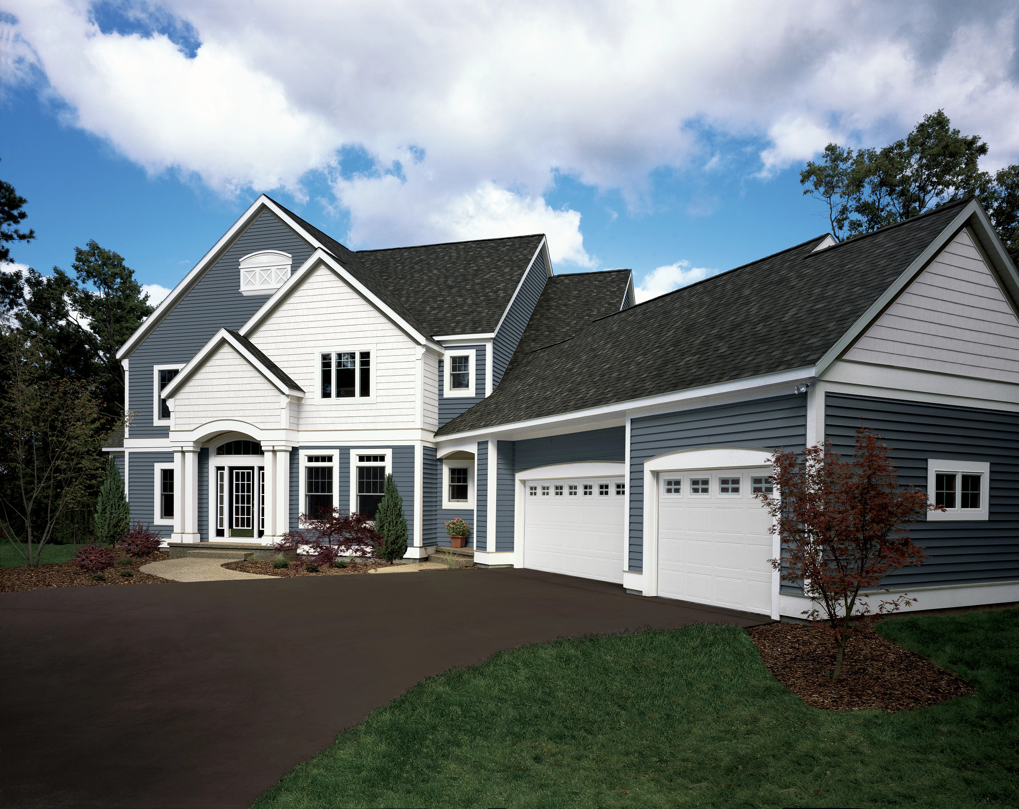 A beautiful home with Vinyl Masters windows, new roof, and vinyl siding installed